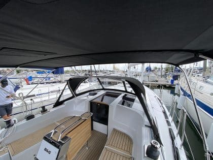 Hanse 348 bimini with Sunbrella fabric and polished stainless steel frame for UV protection.