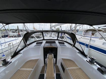Hanse 348 bimini with Sunbrella fabric and polished stainless steel frame for UV protection.