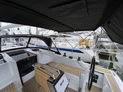 Hanse 348 bimini with Sunbrella fabric and polished stainless steel frame for UV protection.