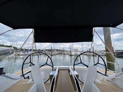 Hanse 348 bimini with Sunbrella fabric and polished stainless steel frame for UV protection.