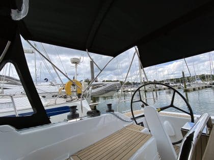 Hanse 348 bimini with Sunbrella fabric and polished stainless steel frame for UV protection.