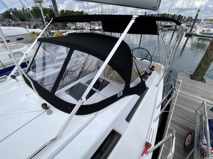 Hanse 348 bimini with Sunbrella fabric and polished stainless steel frame for UV protection.