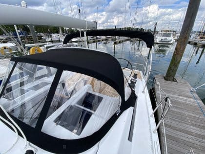 Hanse 348 bimini with Sunbrella fabric and polished stainless steel frame for UV protection.