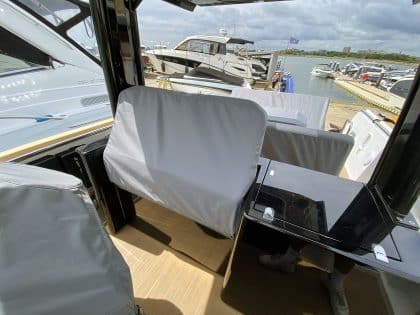 Fjord 38 XP with custom seating, table, and console covers installed for protection and style.