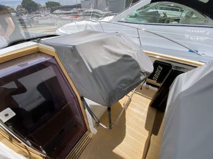 Fjord 38 XP with custom seating, table, and console covers installed for protection and style.