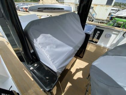 Fjord 38 XP with custom seating, table, and console covers installed for protection and style.