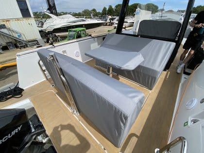 Fjord 38 XP with custom seating, table, and console covers installed for protection and style.