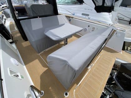 Fjord 38 XP with custom seating, table, and console covers installed for protection and style.