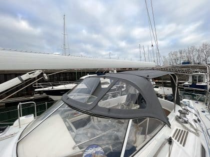 Full view of a Moody 54 yacht with a newly designed sprayhood featuring a modern framework and premium fabric.