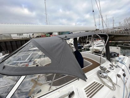 Full view of a Moody 54 yacht with a newly designed sprayhood featuring a modern framework and premium fabric.