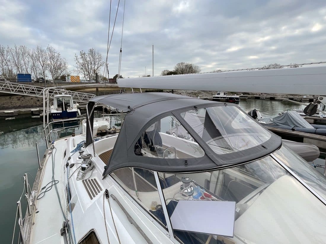 Full view of a Moody 54 yacht with a newly designed sprayhood featuring a modern framework and premium fabric.