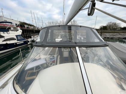 Full view of a Moody 54 yacht with a newly designed sprayhood featuring a modern framework and premium fabric.