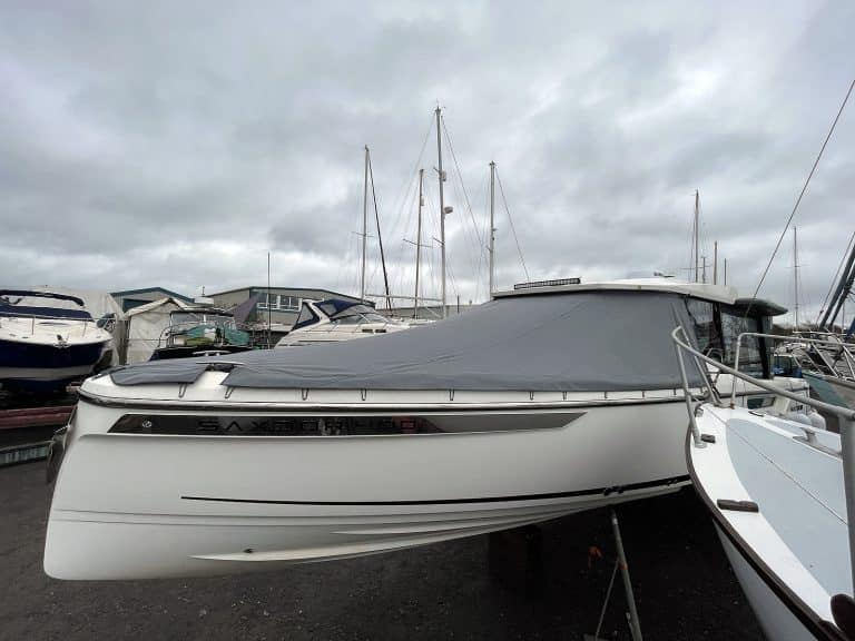 Forward deck and seating area of Saxdor 400 GTC with a custom-fitted Sunbrella fabric cover